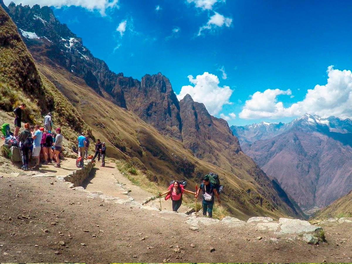 The steep stone steps approaching Dead Woman's Pass at 4,215m on the Classic Inca Trail — trekkers ascending in single file, Cusco Peru