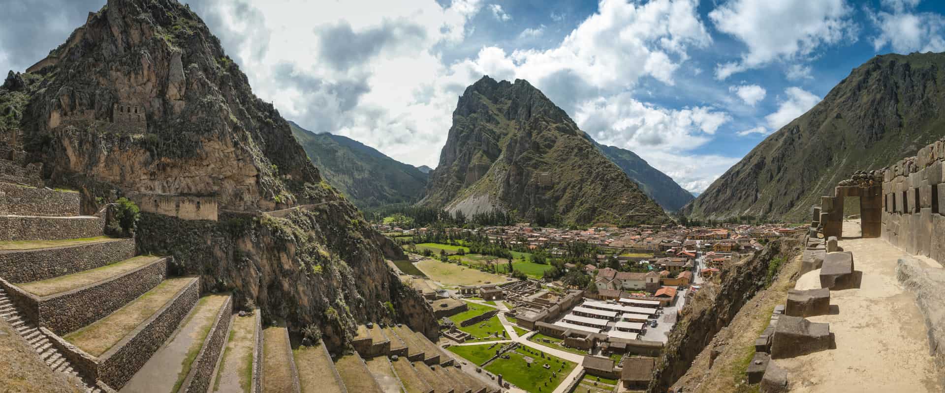 Inca ruins in the Sacred Valley — terraced stone structures against Andean peaks, Cusco Peru
