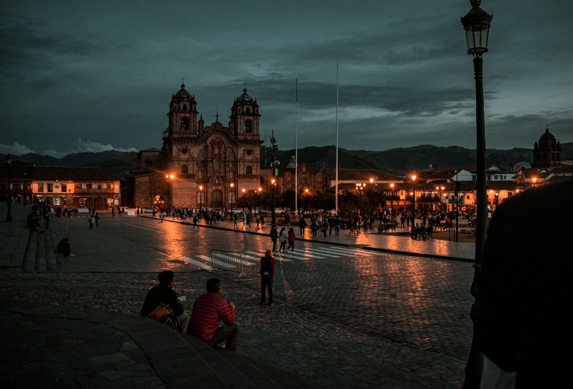 Plaza de Armas Cusco at night — Cathedral and La Compañía de Jesús illuminated, cobblestone square, 3,400m altitude, Cusco Peru