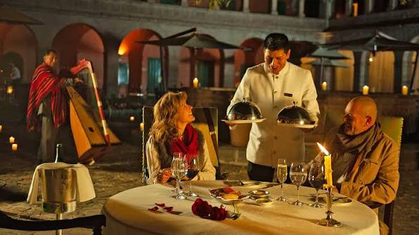Rooftop restaurant terrace overlooking Plaza de Armas and Cusco Cathedral at dusk, Cusco, Peru