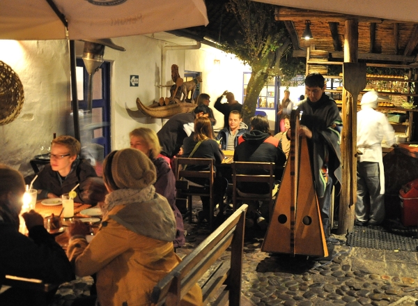 Open-air courtyard restaurant with wood-fired clay oven in San Blas, Cusco, Peru