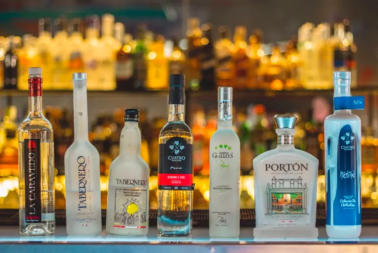 Bottles representing the four types of Peruvian pisco: Puro, Aromático, Acholado, and Mosto Verde
